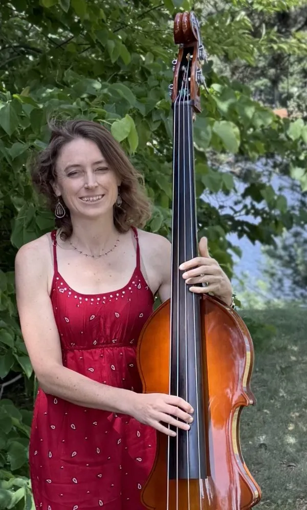 Anne Luna in a red dress standing with an upright bass