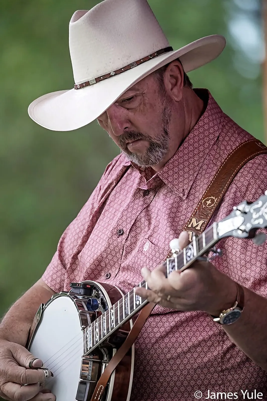 Mark Krider picking banjo on stage
