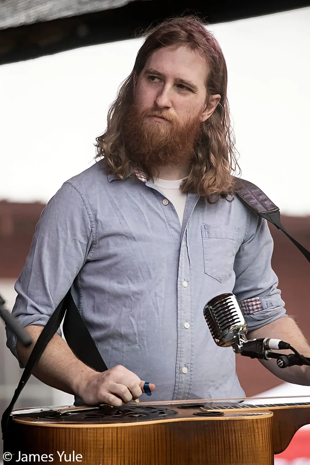 Adam Bachman at the microphone behind his resonator guitar